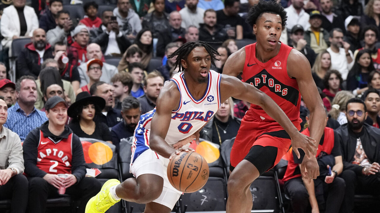 TORONTO, ON - OCTOBER 28: Tyrese Maxey #0 of the Philadelphia 76ers drives against Scottie Barnes #4 of the Toronto Raptors during the first half of their basketball game at the Scotiabank Arena on October 28, 2023 in Toronto, Ontario, Canada. NOTE TO USER: User expressly acknowledges and agrees that, by downloading and/or using this Photograph, user is consenting to the terms and conditions of the Getty Images License Agreement.
