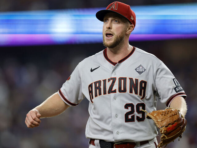 ARLINGTON, TEXAS - OCTOBER 28: Merrill Kelly #29 of the Arizona Diamondbacks walks across the field after the fifth inning against the Texas Rangers during Game Two of the World Series at Globe Life Field on October 28, 2023 in Arlington, Texas.