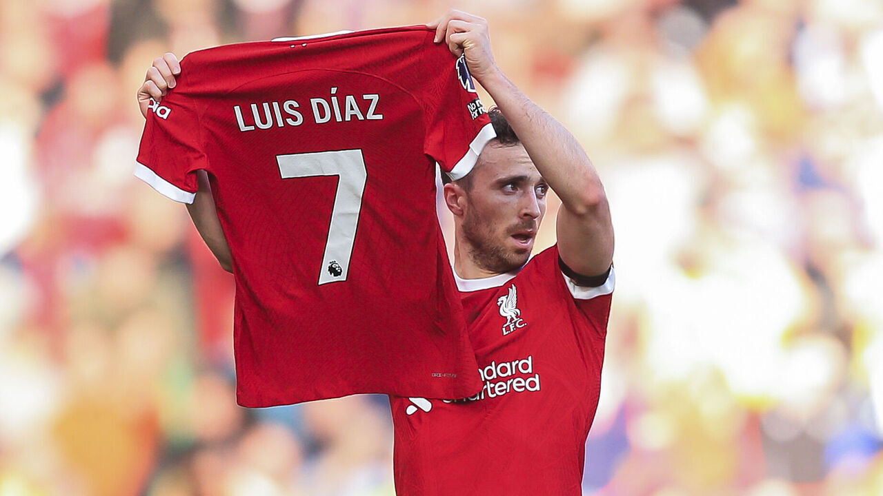 LIVERPOOL, ENGLAND - OCTOBER 29: Diogo Jota of Liverpool holds the shirt of teammate Luis Diaz after scoring their first goal to make the score 1-0 during the Premier League match between Liverpool FC and Nottingham Forest at Anfield on October 29, 2023 in Liverpool, England.