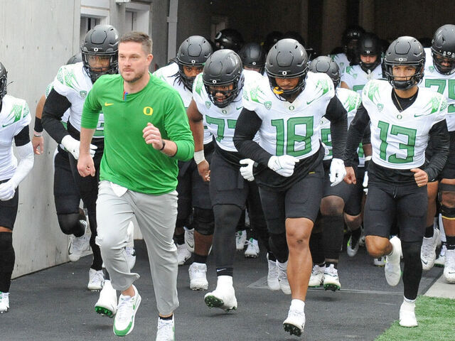 SALT LAKE CITY, UT - OCTOBER 28: Oregon Ducks head coach Dan Lanning runs with his team to the field before a college football game between the Oregon Ducks and Utah Utes on October 28, 2023 at Rice Eccles Stadium at Salt Lake City, Utah.