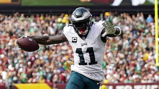 LANDOVER, MARYLAND - OCTOBER 29: Emmanuel Forbes #13 of the Washington Commanders tackles A.J. Brown #11 of the Philadelphia Eagles in the second quarter of a game at FedExField on October 29, 2023 in Landover, Maryland.