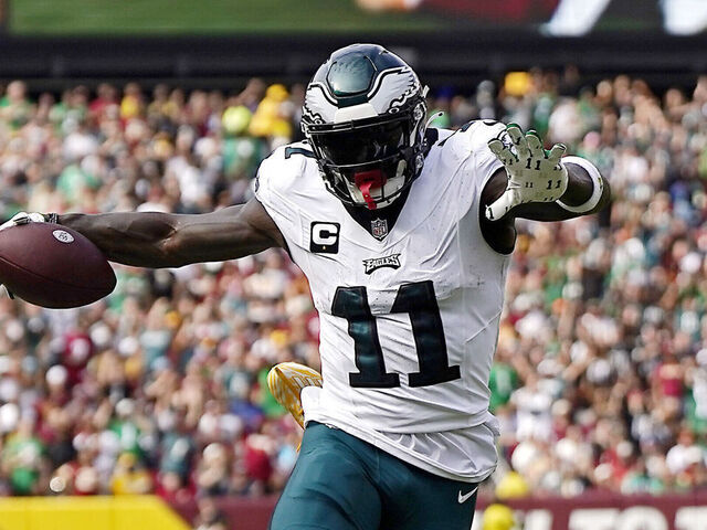 LANDOVER, MARYLAND - OCTOBER 29: Emmanuel Forbes #13 of the Washington Commanders tackles A.J. Brown #11 of the Philadelphia Eagles in the second quarter of a game at FedExField on October 29, 2023 in Landover, Maryland.