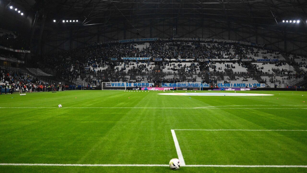 This photograph shows spectators leaving the Stade Velodrome in Marseille, southern France on October 29, 2023, after the French Ligue 1 football match between Marseille and Lyon was postponed after the Lyon's travelling team bus was attacked with stones as it entered the Stade Velodrome ahead of the match. Lyon head coach Fabio Grosso and his assistant were injured during the attack.