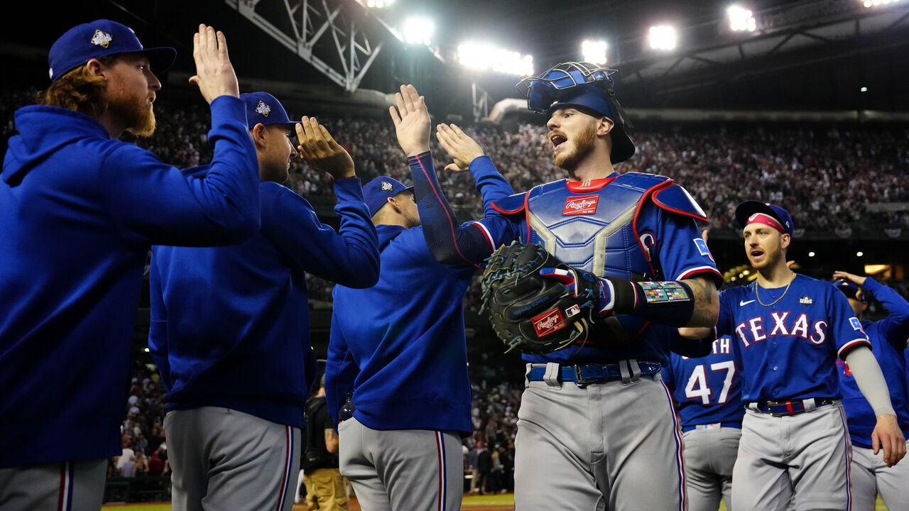 PHOENIX, AZ - OCTOBER 30: Jonah Heim #28 of the Texas Rangers celebrates with teammates after their win in Game 3 of the 2023 World Series between the Texas Rangers and the Arizona Diamondbacks at Chase Field on Monday, October 30, 2023 in Phoenix, Arizona. The Rangers defeated the Diamondbacks 3-1 to lead the series 2-1.