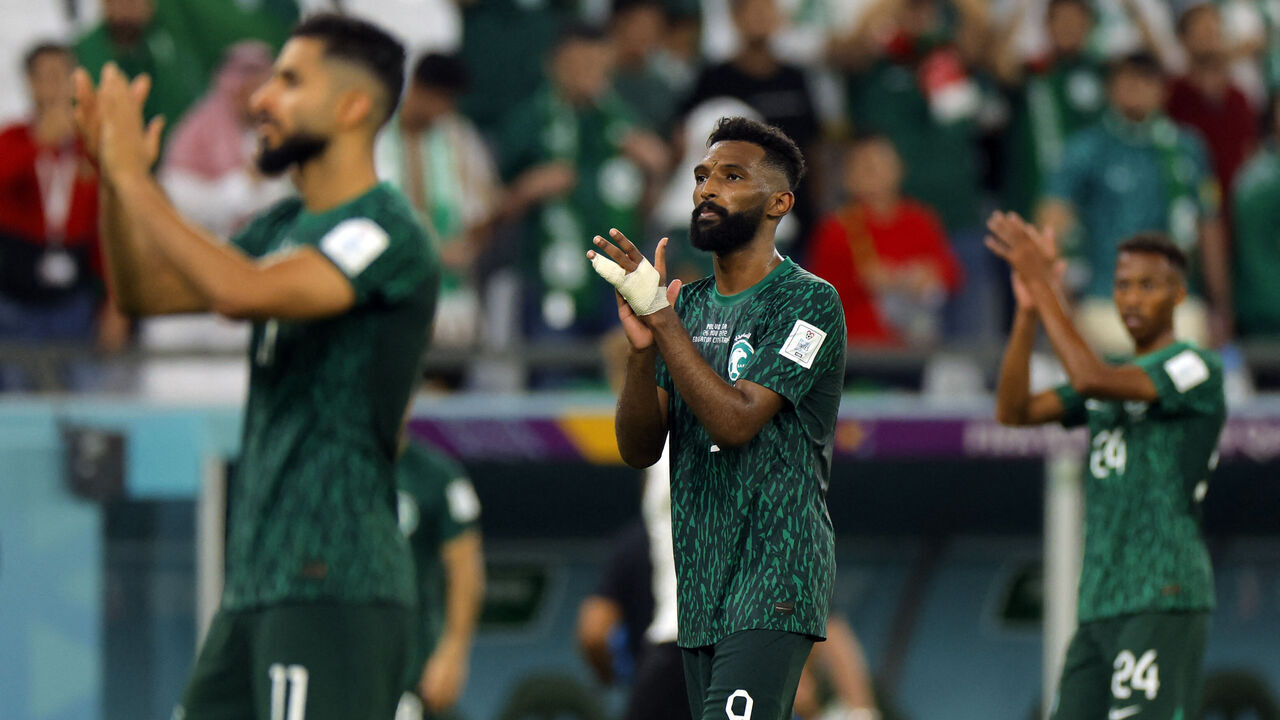 Saudi Arabia's forward #11 Saleh Al-Shehri, Saudi Arabia's forward #09 Firas Al-Buraikan and Saudi Arabia's midfielder #24 Nasser Al-Dawsari acknowledge fans after being defeated 2-0 by Poland in the Qatar 2022 World Cup Group C football match between Poland and Saudi Arabia at the Education City Stadium in Al-Rayyan, west of Doha on November 26, 2022.