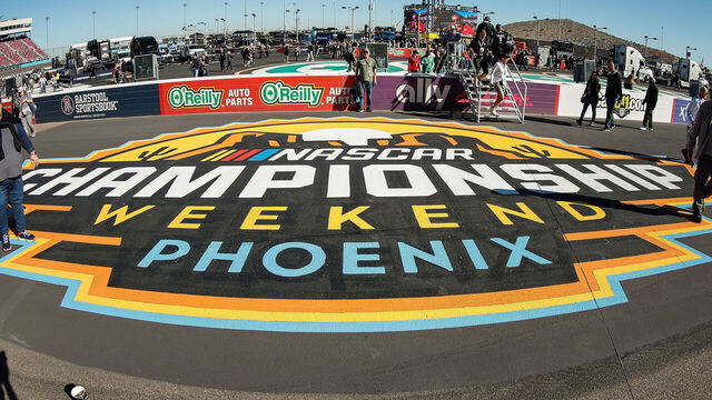 AVONDALE, AZ - NOVEMBER 06: Fans walk by the NASCAR Championship Weekend logo before the NASCAR Cup Series Championship Race on November 6, 2022 at Phoenix Raceway in Avondale, Arizona.