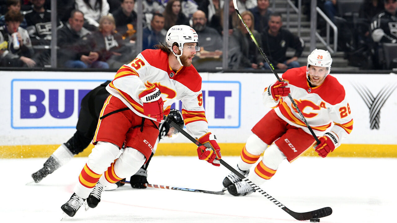 LOS ANGELES, CA - MARCH 20: Calgary Flames Defenceman Noah Hanifin (55) carries the puck as Calgary Flames Center Elias Lindholm (28) turns towards the play during an NHL hockey game between the Calgary Flames and the Los Angeles Kings on March 20th, 2023, at the Crypto.com Arena in Los Angeles, CA.