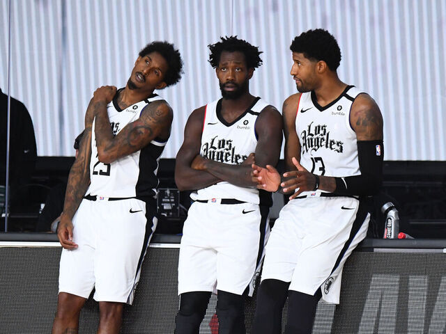 ORLANDO, FL - SEPTEMBER 7: Lou Williams #23 of the LA Clippers, Patrick Beverley #21 of the LA Clippers, and Paul George #13 of the LA Clippers talk on the sidelines during a game against the Denver Nuggets during Round Two, Game Three of the Western Conference Semifinals on September 7, 2020 at the AdventHealth Arena at ESPN Wide World Of Sports Complex in Orlando, Florida. NOTE TO USER: User expressly acknowledges and agrees that, by downloading and/or using this Photograph, user is consenting to the terms and conditions of the Getty Images License Agreement. Mandatory Copyright Notice: Copyright 2020 NBAE