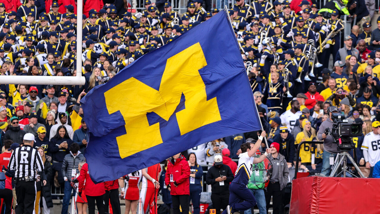 COLUMBUS, OH - NOVEMBER 26: A Michigan Wolverines cheerleader runs the Michigan banner thru the end zone after a Wolverines touchdown during the fourth quarter of the college football game between the Michigan Wolverines and Ohio State Buckeyes on November 26, 2022, at Ohio Stadium in Columbus, OH.