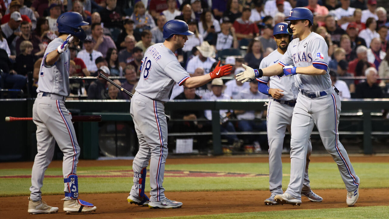 PHOENIX, AZ - OCTOBER 31: Corey Seager #5 of the Texas Rangers celebrates with Mitch Garver #18 after hitting a two-run home run in the second inning during Game 4 of the 2023 World Series between the Texas Rangers and the Arizona Diamondbacks at Chase Field on Tuesday, October 31, 2023 in Phoenix, Arizona.