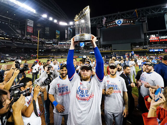 PHOENIX, AZ - NOVEMBER 01: Jordan Montgomery #52 of the Texas Rangers holds up the Commissioner's Trophy after winning Game 5 of the 2023 World Series between the Texas Rangers and the Arizona Diamondbacks at Chase Field on Wednesday, November 1, 2023 in Phoenix, Arizona. The Rangers defeated the Diamondbacks 5-0 to win the World Series.