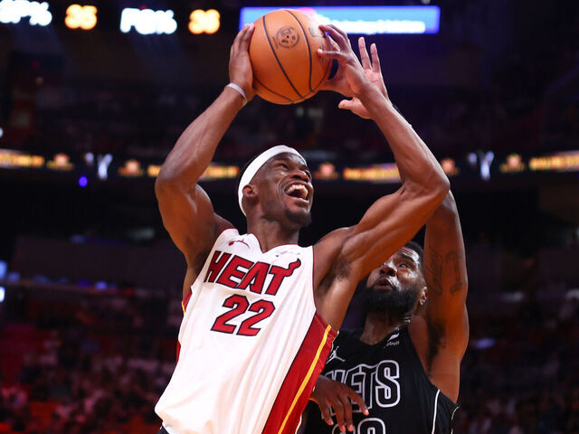 MIAMI, FLORIDA - NOVEMBER 01: Jimmy Butler #22 of the Miami Heat drives to the basket against Royce O'Neale #00 of the Brooklyn Nets during the second quarter of the game at Kaseya Center on November 01, 2023 in Miami, Florida.
