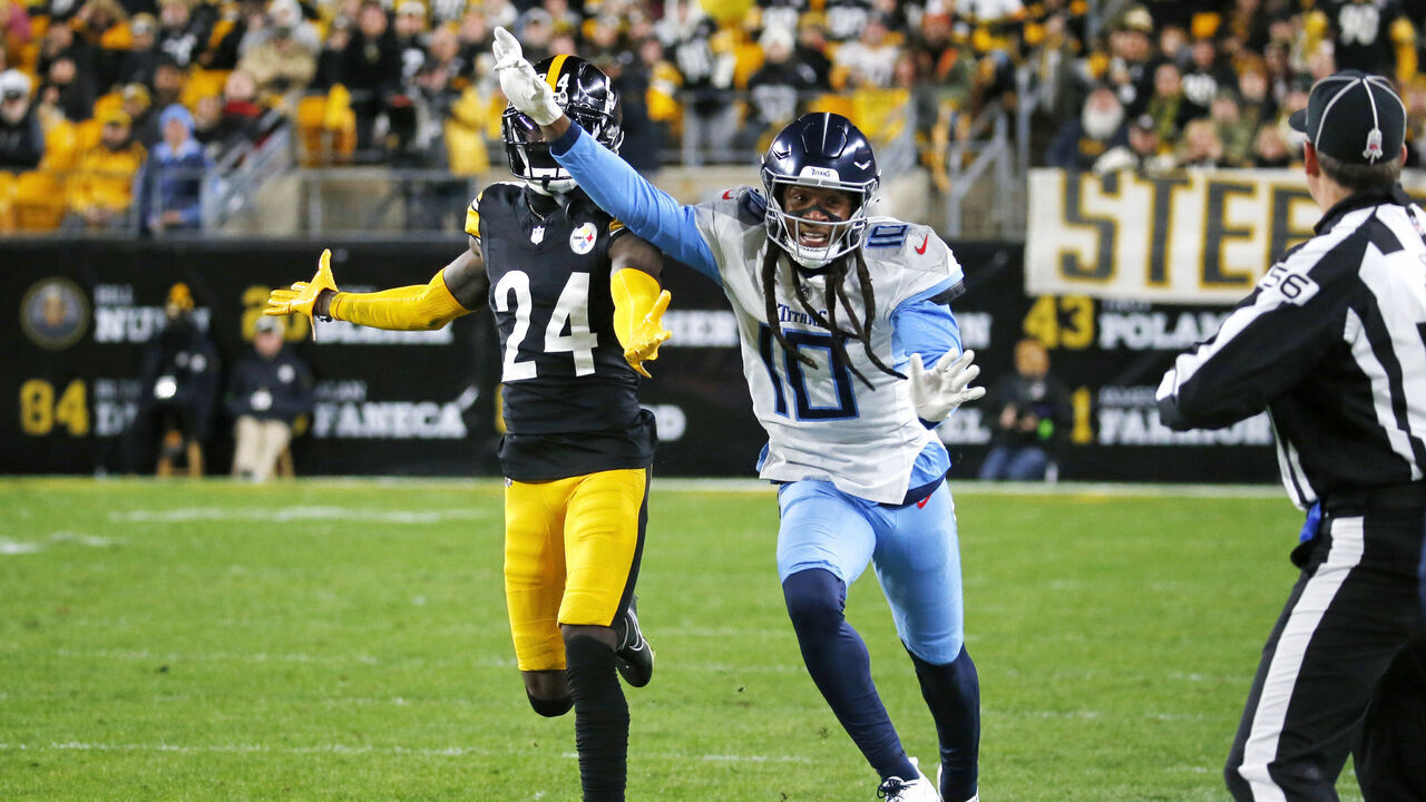 PITTSBURGH, PENNSYLVANIA - NOVEMBER 02: DeAndre Hopkins #10 of the Tennessee Titans and Joey Porter Jr. #24 of the Pittsburgh Steelers run along the sideline in the first half at Acrisure Stadium on November 02, 2023 in Pittsburgh, Pennsylvania.