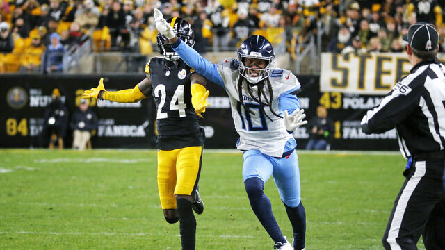 PITTSBURGH, PENNSYLVANIA - NOVEMBER 02: DeAndre Hopkins #10 of the Tennessee Titans and Joey Porter Jr. #24 of the Pittsburgh Steelers run along the sideline in the first half at Acrisure Stadium on November 02, 2023 in Pittsburgh, Pennsylvania.