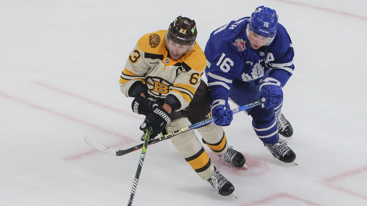 Boston, MA - November 2: Boston Bruins LW Brad Marchand is pressured by Toronto Maple Leafs RW Mitchell Marner in the overtime period. The Bruins beat the Maple Leafs, 3-2, in a shoot-out.