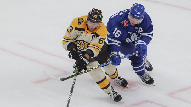 Boston, MA - November 2: Boston Bruins LW Brad Marchand is pressured by Toronto Maple Leafs RW Mitchell Marner in the overtime period. The Bruins beat the Maple Leafs, 3-2, in a shoot-out.