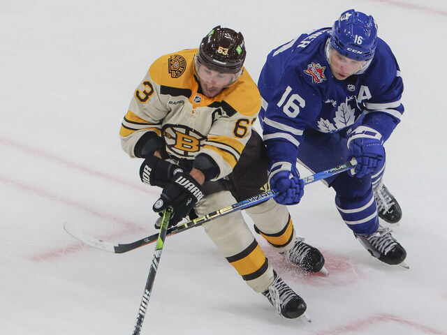 Boston, MA - November 2: Boston Bruins LW Brad Marchand is pressured by Toronto Maple Leafs RW Mitchell Marner in the overtime period. The Bruins beat the Maple Leafs, 3-2, in a shoot-out.