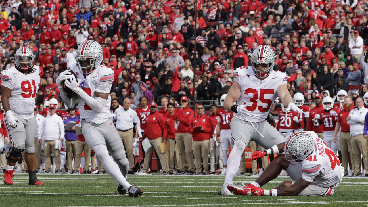 PISCATAWAY, NEW JERSEY - NOVEMBER 4: Cornerback Jordan Hancock #7 of the Ohio State Buckeyes catches a deflected pass from safety Josh Proctor #41and runs for a 93 yard touchdown against the Rutgers Scarlet Knights during the third quarter of a college football game at SHI Stadium on November 4, 2023 in Piscataway, New Jersey. Ohio State defeated Rutgers 35-16.