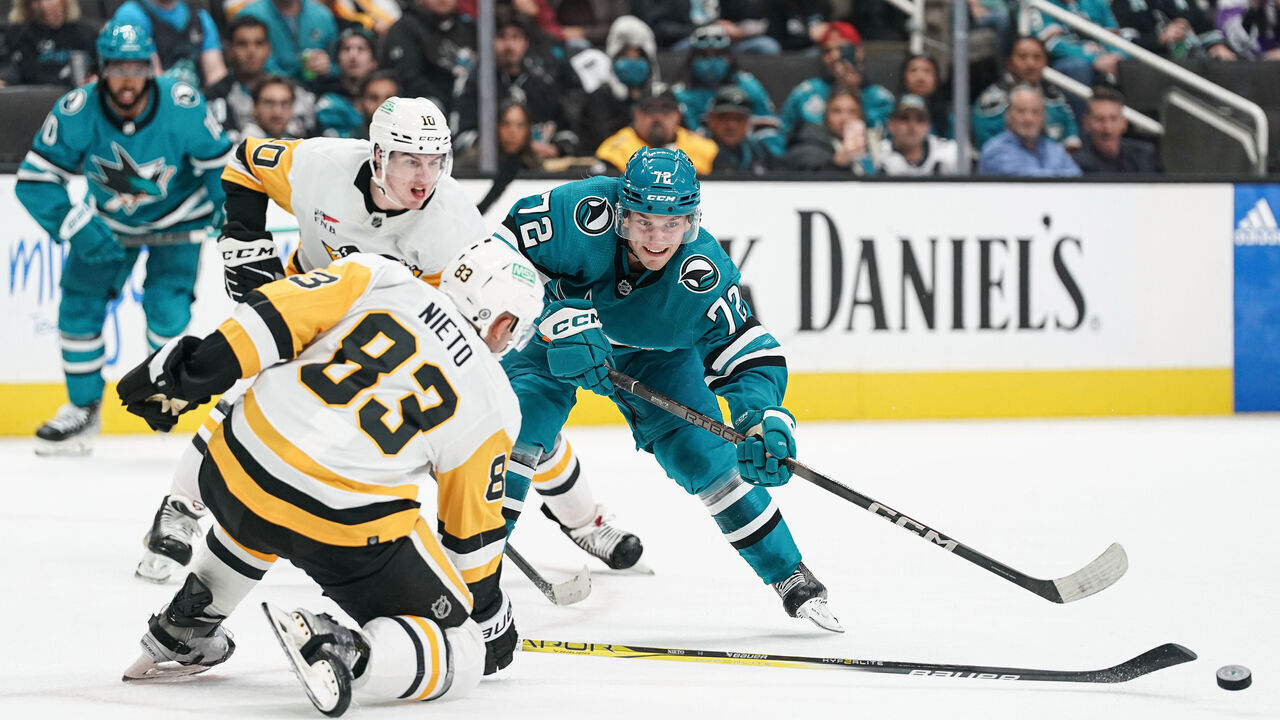 SAN JOSE, CA - NOVEMBER 4: William Eklund #72 of the San Jose Sharks passes the puck against Matt Nieto #83 of the Pittsburgh Penguins at SAP Center on November 4, 2023 in San Jose, California.