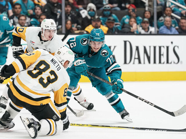 SAN JOSE, CA - NOVEMBER 4: William Eklund #72 of the San Jose Sharks passes the puck against Matt Nieto #83 of the Pittsburgh Penguins at SAP Center on November 4, 2023 in San Jose, California.