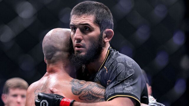 Russia's Islam Makhachev (R) embraces Australia's Alexander Volkanovski after their Lightweight bout during the Ultimate Fighting Championship 294 (UFC) event at the Etihad Arena in Abu Dhabi on October 22, 2023.