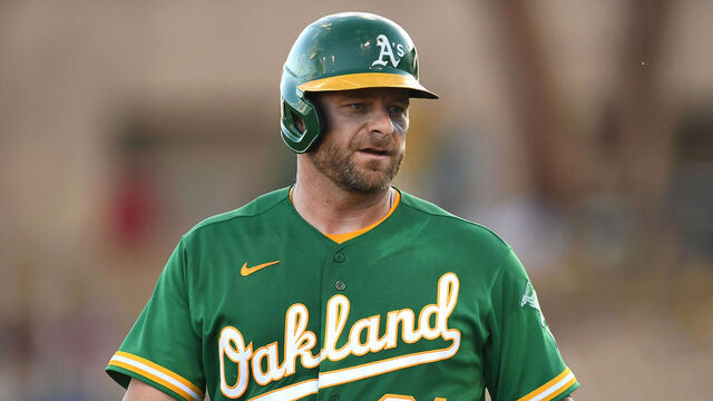 GLENDALE, AZ - MARCH 29, 2022: Stephen Vogt #21 of the Oakland Athletics talks with third base coach Darren Bush #51 during the first inning of an MLB spring training game against the Los Angeles Dodgers at Camelback Ranch on March 29, 2022 in Glendale, Arizona.