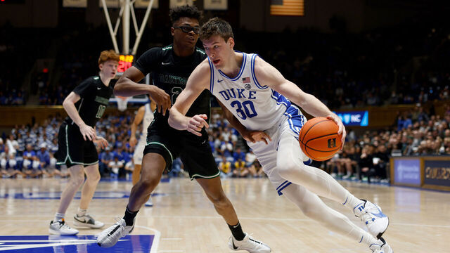 DURHAM, NORTH CAROLINA - NOVEMBER 6: Kyle Filipowski #30 of the Duke Blue Devils drives against Brandon Mitchell-Day #21 of the Dartmouth Big Green during the second half of the game at Cameron Indoor Stadium on November 6, 2023 in Durham, North Carolina. Duke won 92-54.