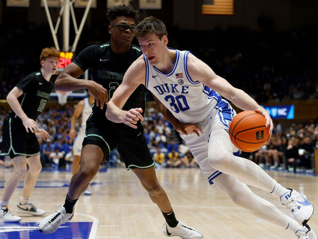 DURHAM, NORTH CAROLINA - NOVEMBER 6: Kyle Filipowski #30 of the Duke Blue Devils drives against Brandon Mitchell-Day #21 of the Dartmouth Big Green during the second half of the game at Cameron Indoor Stadium on November 6, 2023 in Durham, North Carolina. Duke won 92-54.