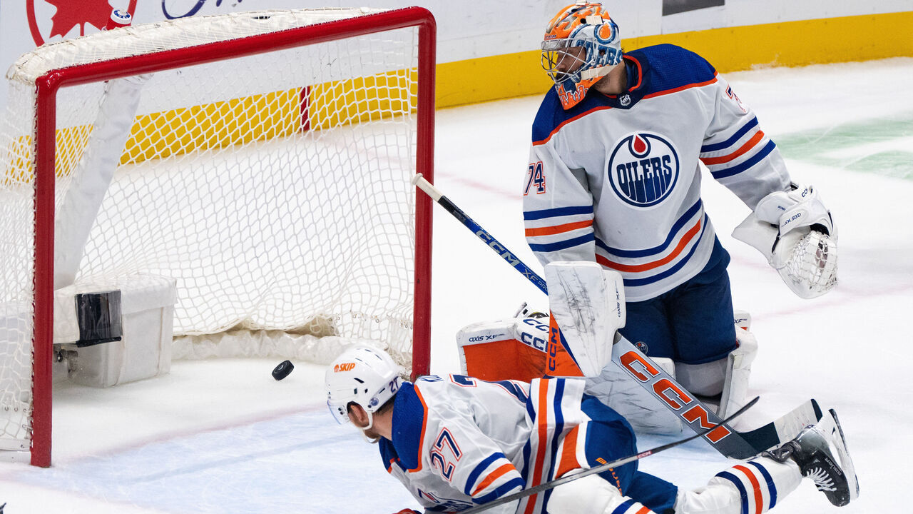 VANCOUVER, BC - NOVEMBER 06: Edmonton Oilers goaltender Stuart Skinner (74) and defenseman Brett Kulak (27) watches the puck go in the net during an NHL game against the Vancouver Canucks at Rogers Arena on November 6, 2023 in Vancouver, B.C.
