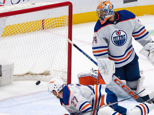 VANCOUVER, BC - NOVEMBER 06: Edmonton Oilers goaltender Stuart Skinner (74) and defenseman Brett Kulak (27) watches the puck go in the net during an NHL game against the Vancouver Canucks at Rogers Arena on November 6, 2023 in Vancouver, B.C.