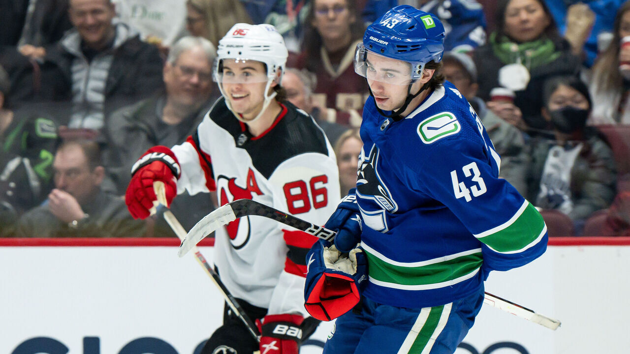 VANCOUVER, BC - MARCH 15: Vancouver Canucks defenseman Quinn Hughes (43) and New Jersey Devils center Jack Hughes (86) after a whistle during their NHL game at Rogers Arena on March 15, 2022 in Vancouver, British Columbia, Canada.