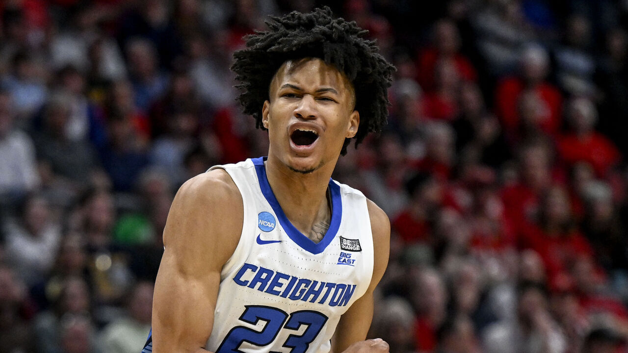 DENVER, CO - MARCH 17: Trey Alexander (23) of the Creighton Bluejays roars after hitting a difficult shot in the paint over Ernest Ross (24) of the North Carolina State Wolfpack during the second half of Creightons 72-63 win in an opening round NCAA mens basketball tournament game at Ball Arena in Denver on Friday, March 17, 2023.