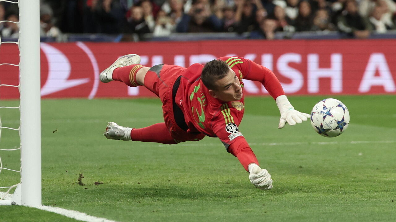 Real Madrid's Ukrainian goalkeeper #13 Andriy Lunin stops the ball during the UEFA Champions League group C football match between Real Madrid CF and SC Braga at the Santiago Bernabeu stadium in Madrid on November 8, 2023.
