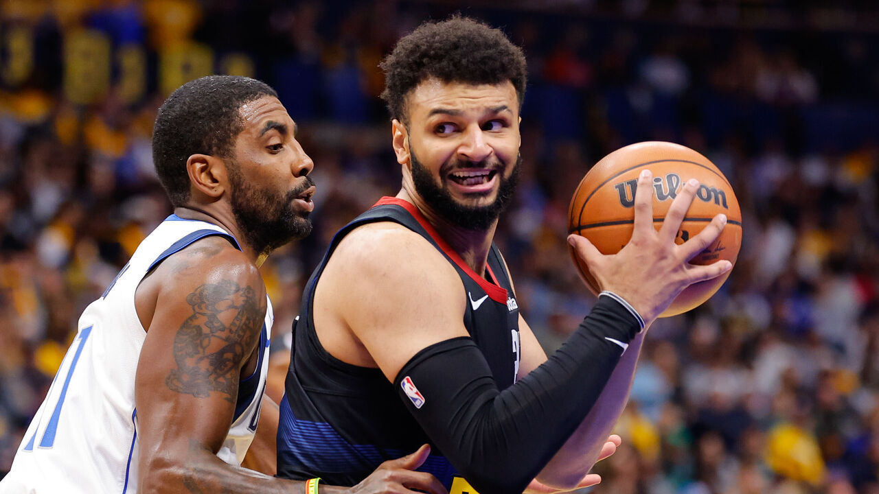 DENVER, COLORADO - NOVEMBER 3: Jamal Murray #27 of the Denver Nuggets handles the ball against Kyrie Irving #11 of the Dallas Mavericks during the first quarter in the NBA In-Season Tournament game at Ball Arena on November 3, 2023 in Denver, Colorado.
