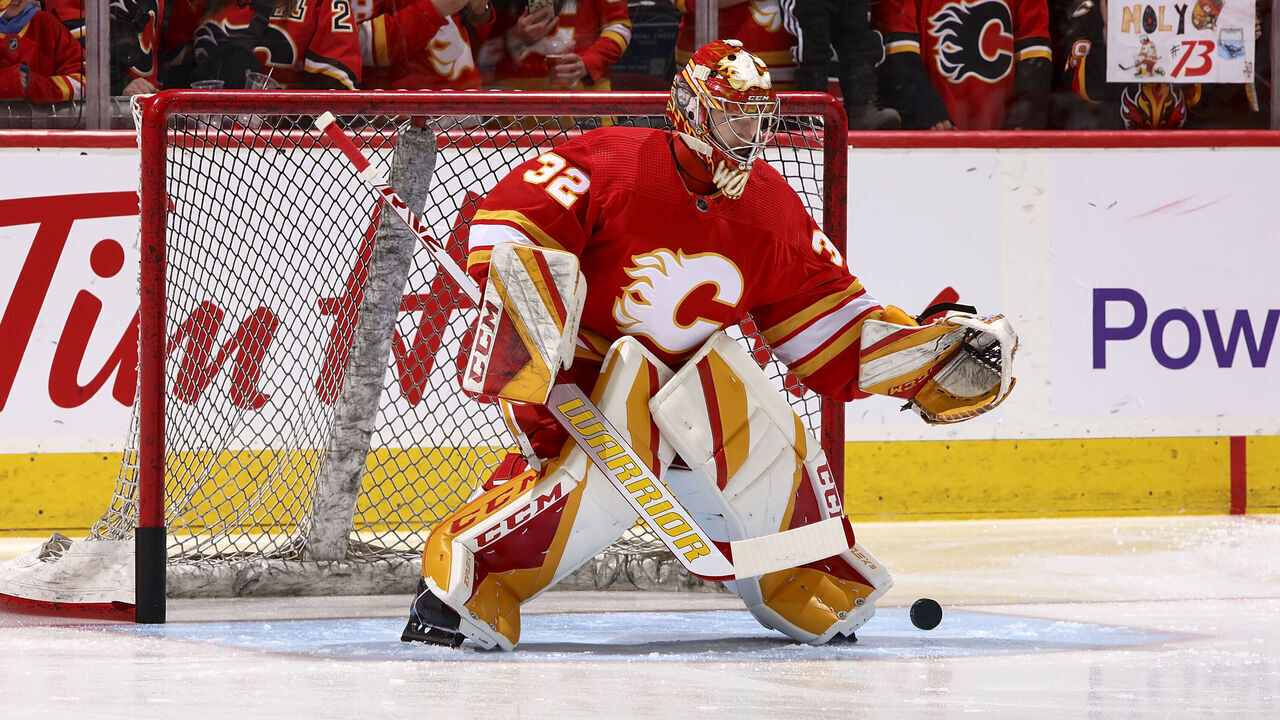 CALGARY, AB - APRIL 12: Dustin Wolf #32 of the Calgary Flames in net during warmup in his NHL debut against the San Jose Sharks at Scotiabank Saddledome on April 12, 2023 in Calgary, Alberta, Canada.