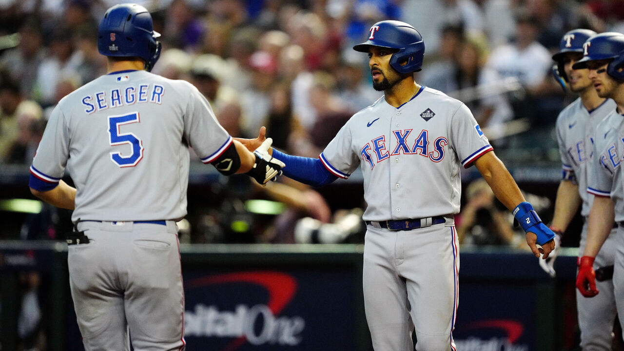 PHOENIX, AZ - OCTOBER 31: Corey Seager #5 of the Texas Rangers celebrates with teammate Marcus Semien #2 after hitting a two-run home run in the second inning during Game 4 of the 2023 World Series between the Texas Rangers and the Arizona Diamondbacks at Chase Field on Tuesday, October 31, 2023 in Phoenix, Arizona.