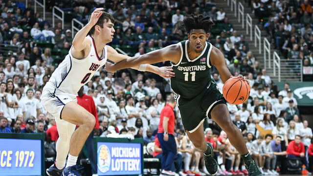 EAST LANSING, MI - NOVEMBER 09: Michigan State Spartans guard A.J. Hoggard (11) drives to the basket against Southern Indiana guard Ryan Hall (0) during a college basketball game between the Michigan State Spartans and Southern Indiana Screaming Eagles on November 9, 2023 at the Breslin Center in East Lansing, MI.