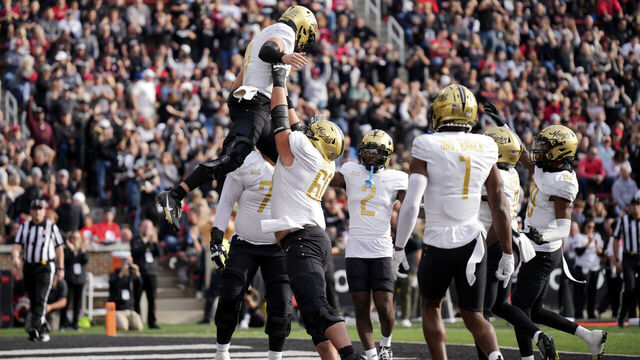CINCINNATI, OHIO - NOVEMBER 04: John Rhys Plumlee #10 of the UCF Knights celebrates as he is lifted by Drake Metcalf #60 after scoring a touchdown in the first half against the Cincinnati Bearcats at Nippert Stadium on November 04, 2023 in Cincinnati, Ohio.