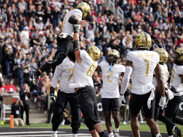CINCINNATI, OHIO - NOVEMBER 04: John Rhys Plumlee #10 of the UCF Knights celebrates as he is lifted by Drake Metcalf #60 after scoring a touchdown in the first half against the Cincinnati Bearcats at Nippert Stadium on November 04, 2023 in Cincinnati, Ohio.