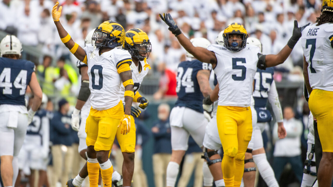 STATE COLLEGE, PENNSYLVANIA - NOVEMBER 11: Mike Sainristil #0 and Josaiah Stewart #5 of the Michigan Wolverines react after making a play during the first half of a college football game against the Penn State Nittany Lions at Beaver Stadium on November 11, 2023 in State College, Pennsylvania.