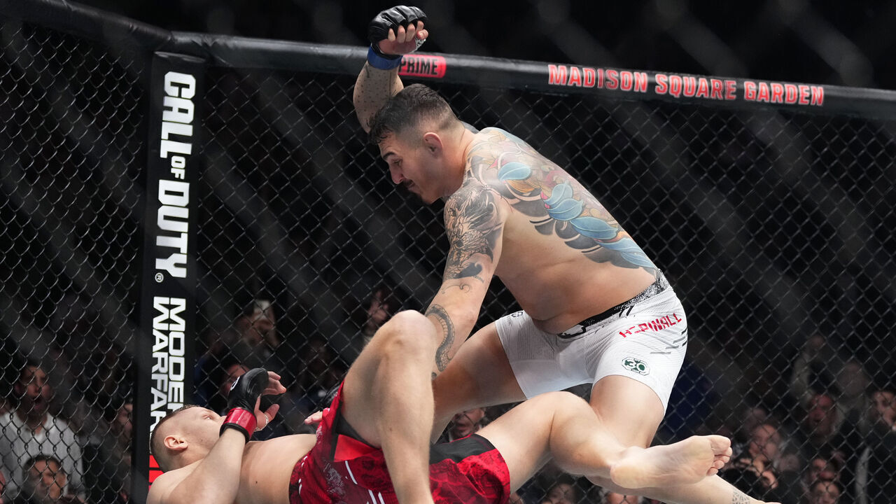 NEW YORK, NEW YORK - NOVEMBER 11: Tom Aspinall of England knocks down Sergei Pavlovich of Russia in the interim UFC heavyweight championship fight during the UFC 295 event at Madison Square Garden on November 11, 2023 in New York City.