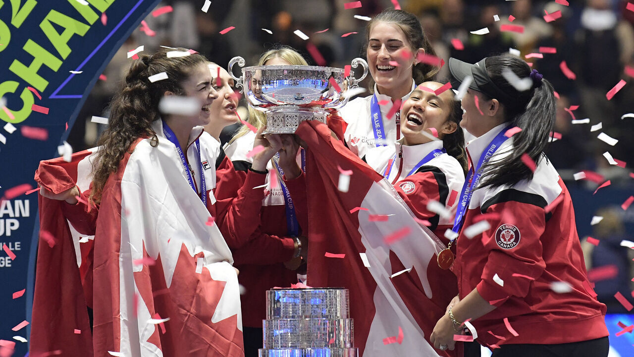 The members of team Canada hold their trophy as they celebrate on the podium after winning the Billie Jean King Cup Finals 2023 in La Cartuja stadium in Seville on November 12, 2023.
