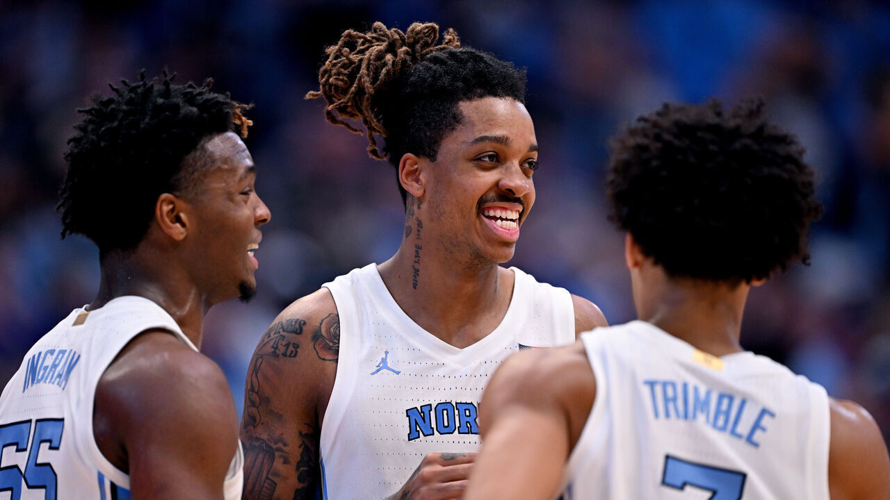 CHAPEL HILL, NORTH CAROLINA - NOVEMBER 12: Armando Bacot #5 talks with teammates Harrison Ingram #55 and Seth Trimble #7 of the North Carolina Tar Heels during the second half of the game against the Lehigh Mountain Hawks at the Dean E. Smith Center on November 12, 2023 in Chapel Hill, North Carolina. The Tar Heels won 90-68.