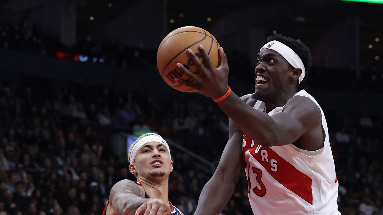 TORONTO, ON- NOVEMBER 13 - Toronto Raptors forward Pascal Siakam (43) sneaks past Washington Wizards forward Kyle Kuzma (33) as the Toronto Raptors after being down more than 20 points come back to beat the Washington Wizards 111-107 at Scotiabank Arena in Toronto. November 13, 2023. (Steve Russell/Toronto Star via Getty Images)
