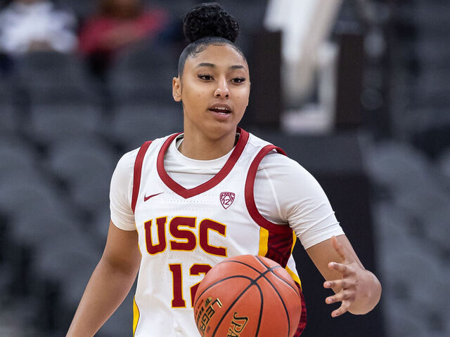 LAS VEGAS, NEVADA - NOVEMBER 6: JuJu Watkins #12 of the USC Trojans brings the ball up court against the Ohio State Buckeyes during the Naismith Hall of Fame Series at T-Mobile Arena on November 6, 2023 in Las Vegas, Nevada.