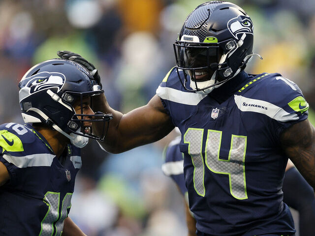 SEATTLE, WASHINGTON - JANUARY 02: DK Metcalf #14 of the Seattle Seahawks celebrates his touchdown catch with Tyler Lockett #16 during the third quarter against the Detroit Lions at Lumen Field on January 02, 2022 in Seattle, Washington.
