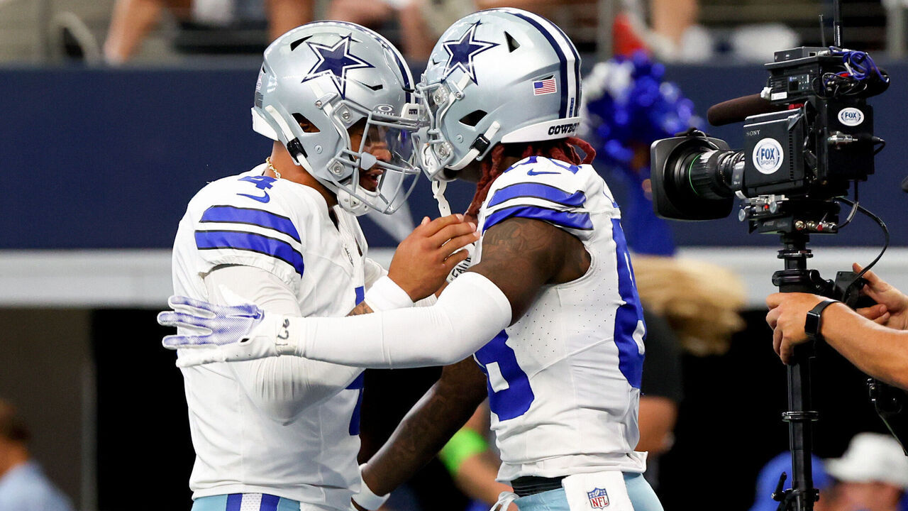 ARLINGTON, TEXAS - OCTOBER 01: Dak Prescott #4 of the Dallas Cowboys celebrates with CeeDee Lamb #88 of the Dallas Cowboys after Lamb's receiving touchdown during the first quarter against the New England Patriots at AT&T Stadium on October 01, 2023 in Arlington, Texas.