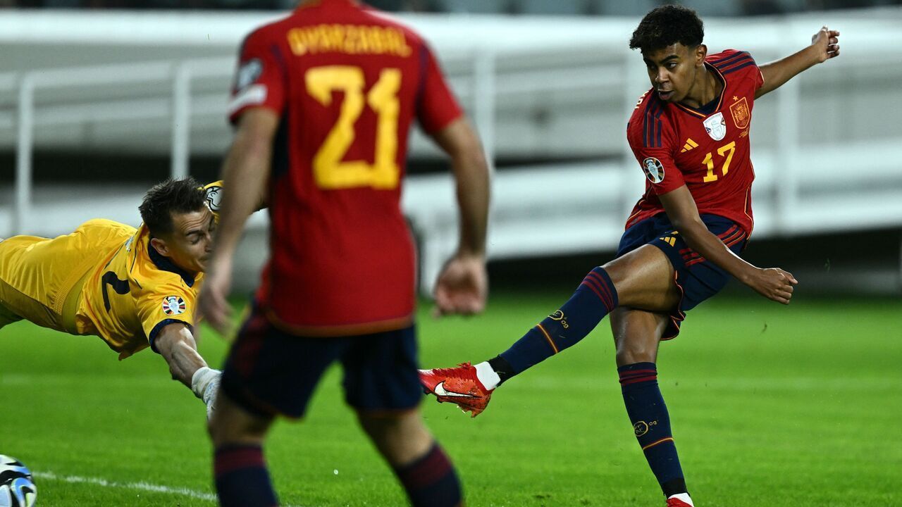 Spain's forward #17 Lamine Yamal (R) shoots to score his team's first goal during the UEFA Euro 2024 Group A qualifying football match between Cyprus and Spain at the Alphamega Stadium in Limassol on November 16, 2023.