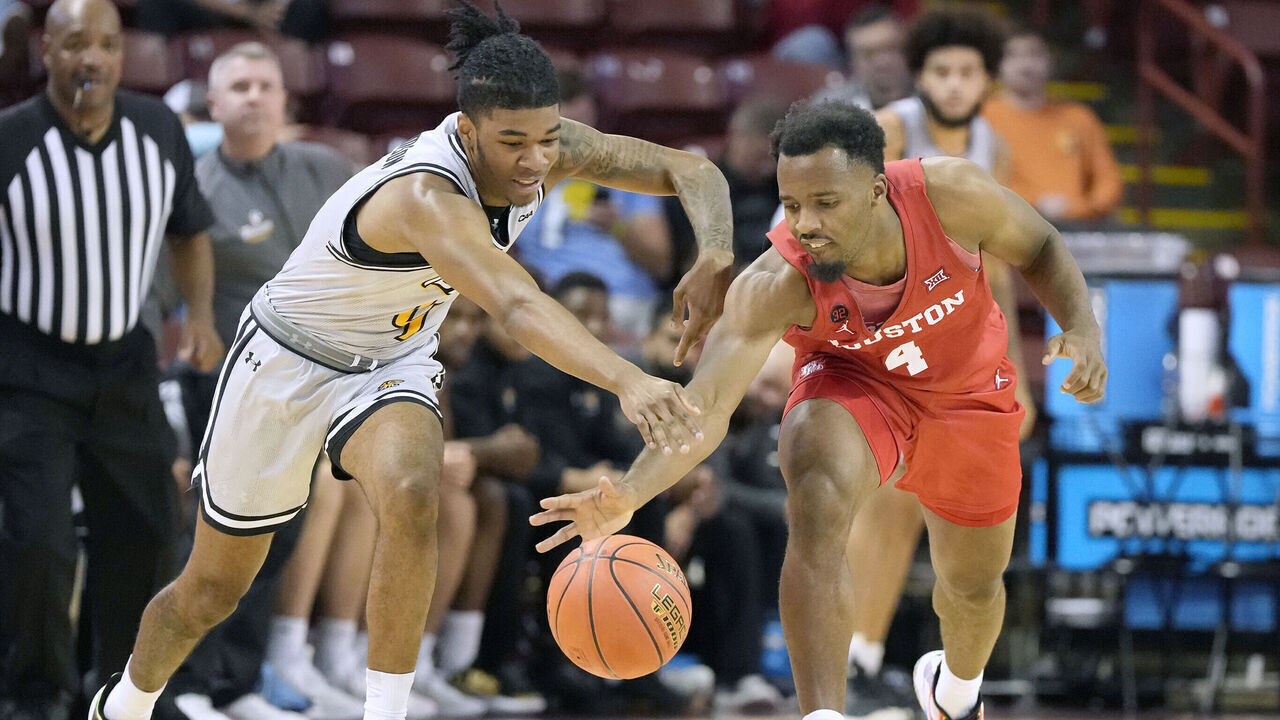 CHARLESTON, SC - NOVEMBER 16: LJ Cryer #4 of the Houston Cougars steals the ball from Dylan Williamson #4 of the Towson Tigers in the second half during day one of the Shriners Children's Charleston Classic college basketball game at the TD Arena on November 16, 2023 in Charleston, South Carolina.
