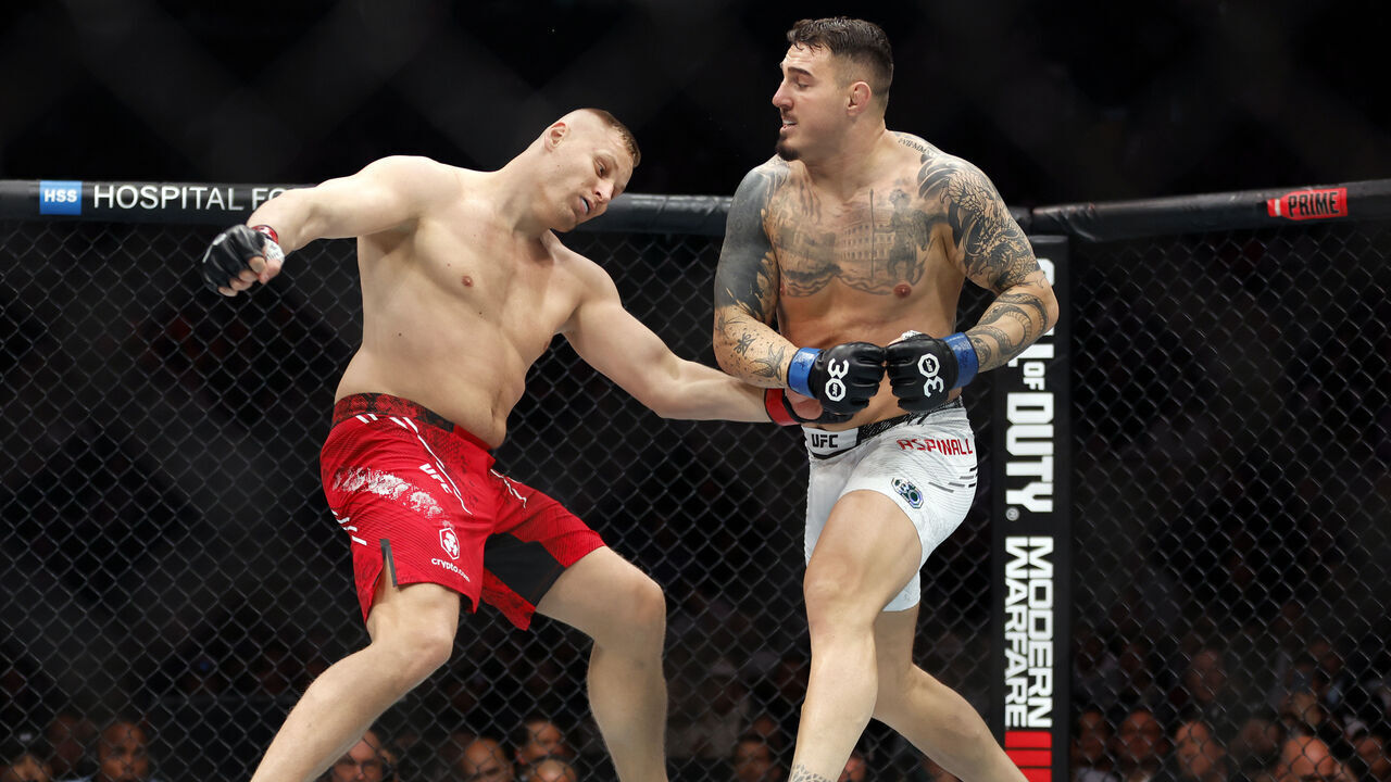 NEW YORK, NEW YORK - NOVEMBER 11: (R-L) Tom Aspinall of England knocks out Sergei Pavlovich of Russia in the interim UFC heavyweight championship fight during the UFC 295 event at Madison Square Garden on November 11, 2023 in New York City.